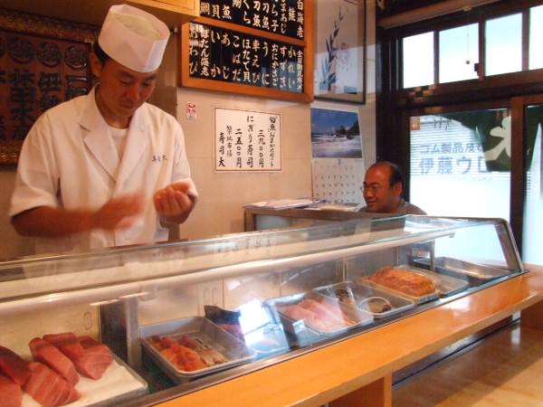 The intimate counter seating of Sushi Dai, known for being a popular breakfast sushi spot in Tokyo.