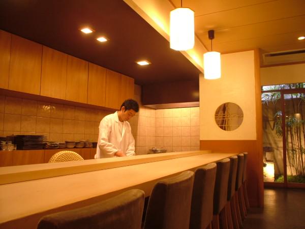 The chef of Sushi Matsumoto, working behind the counter to craft fresh sushi.