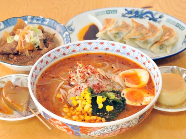 A serving of ramen surrounded by sides like gyoza at Daruma.