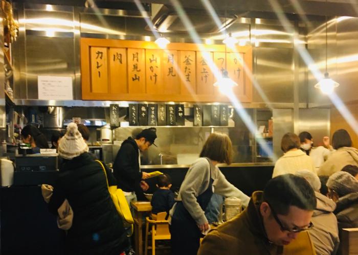 Maruka Udon interior, a packed udon noodle shop in Tokyo