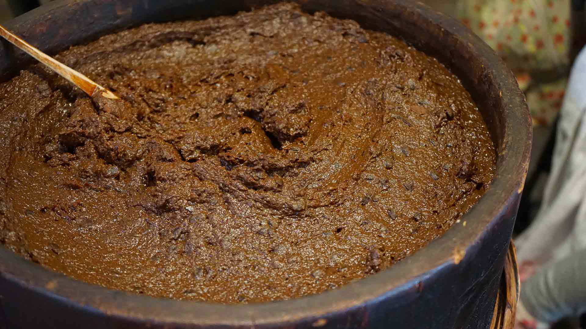 Traditional Japanese miso paste in a wooden barrel