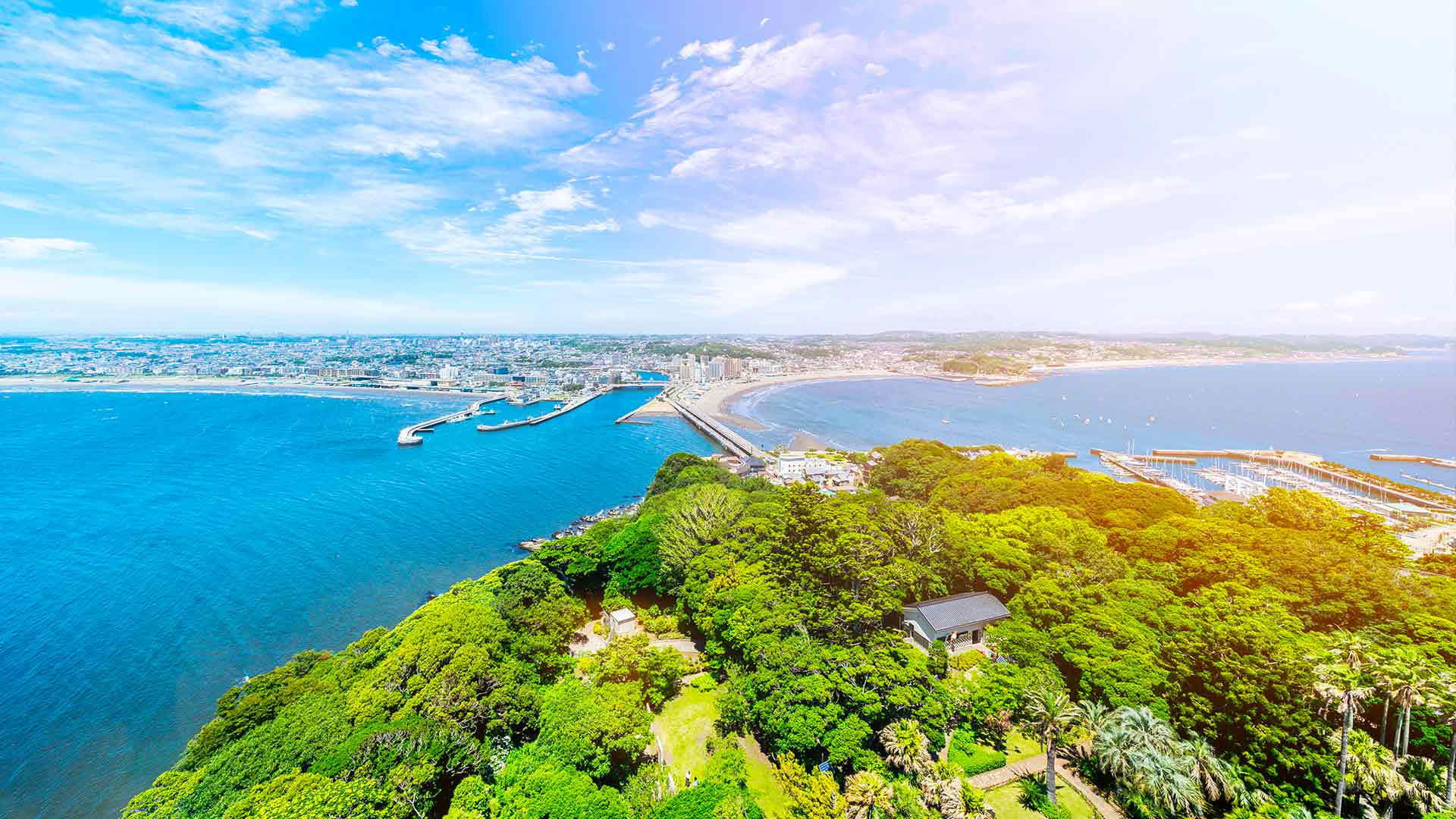 Sunny panoramic view of Enoshima Island and coastline