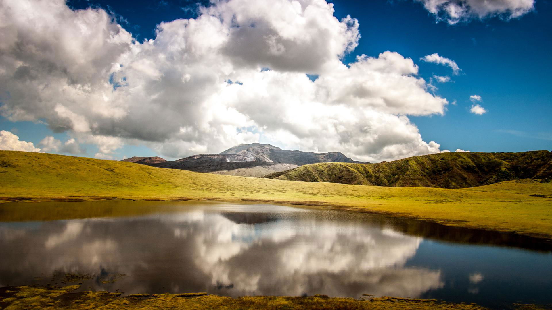 Scenic mountain and lake reflection under cloudy sky