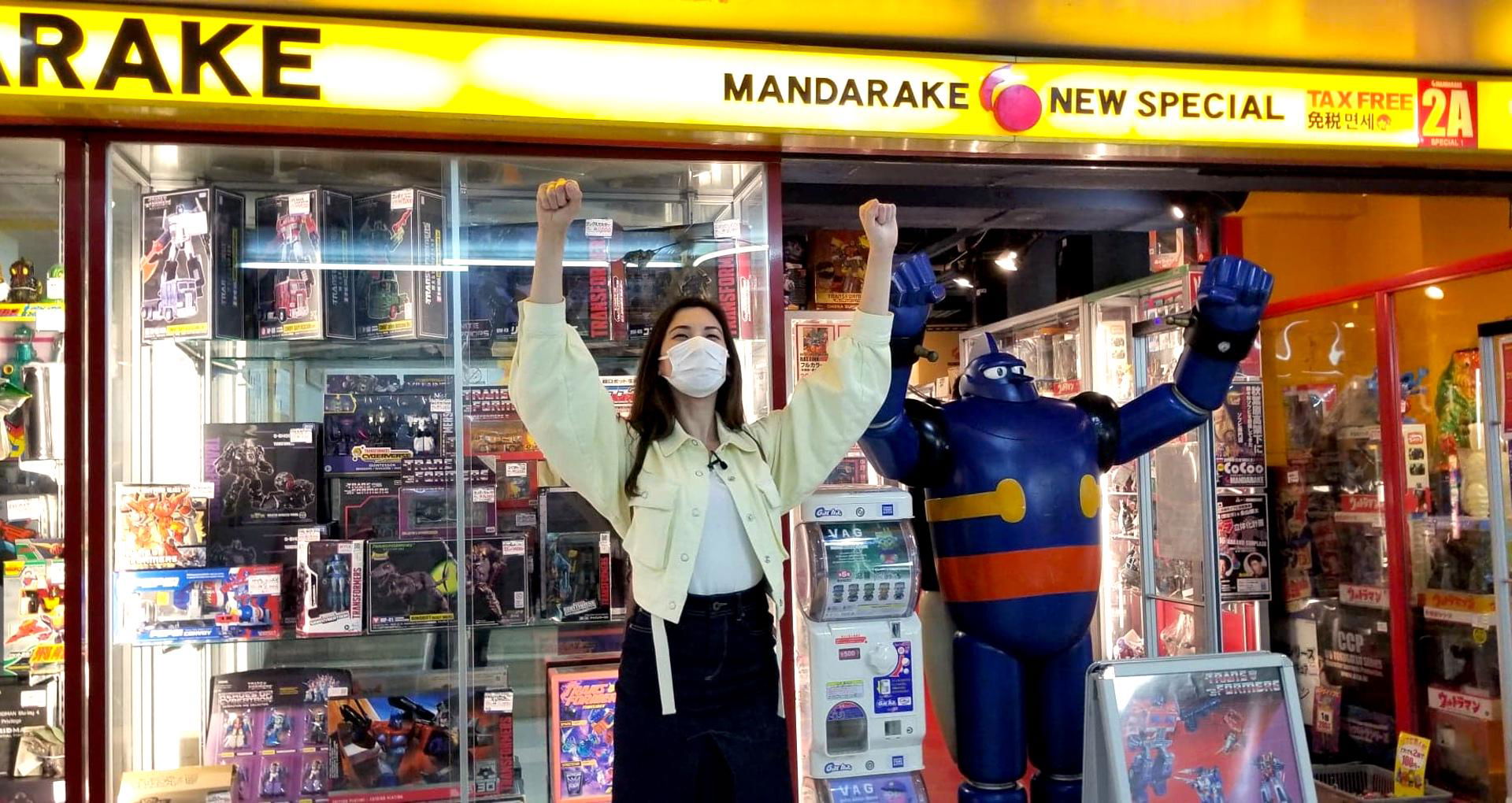 Woman celebrates outside a colorful toy store