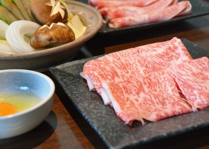 Wagyu sukiyaki -- thin strips of wagyu beef and vegetables to cook in a hot pot, with a raw egg for dipping