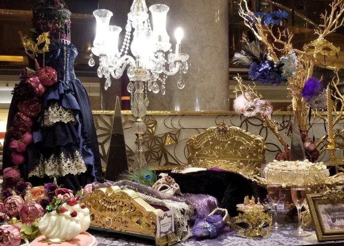 Hilton Tokyo's display for the Marie Antoinette Queen's Masquerade Afternoon Tea with a spread of masks and sweest