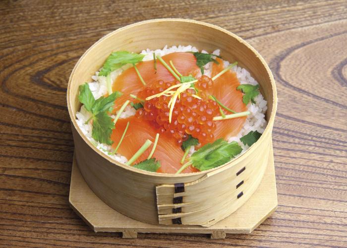 Wooden box with rice and raw fish from Niigata