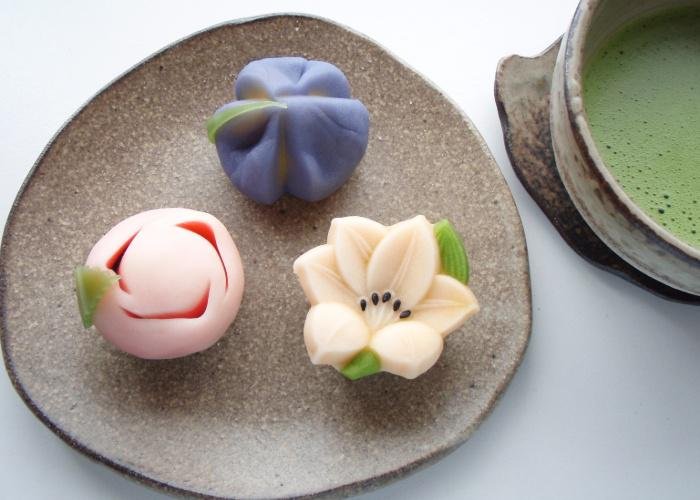 A plate with 3 nerikiri wagashi, Japanese confections, shaped like various flowers