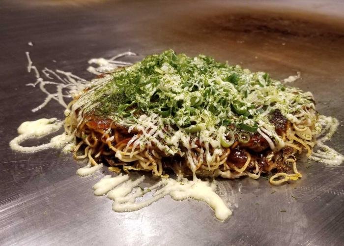 Hiroshima negiyaki, okonomiyaki with soba noodles topped with sauce and negi green onions