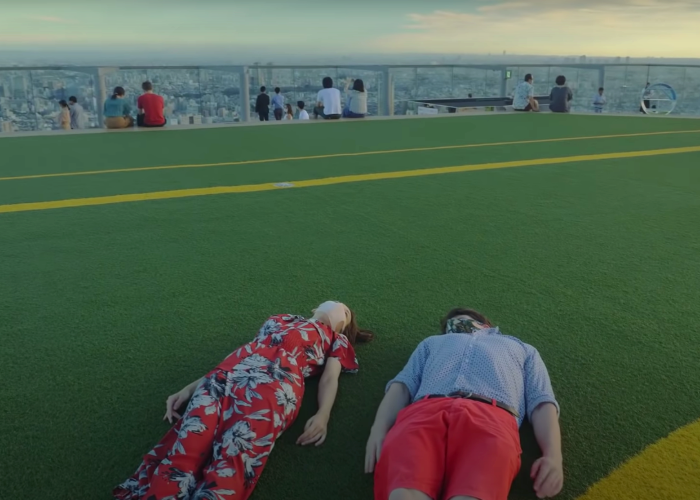 Shizuka Anderson and Kyle Card on the turf of Shibuya Sky in Tokyo