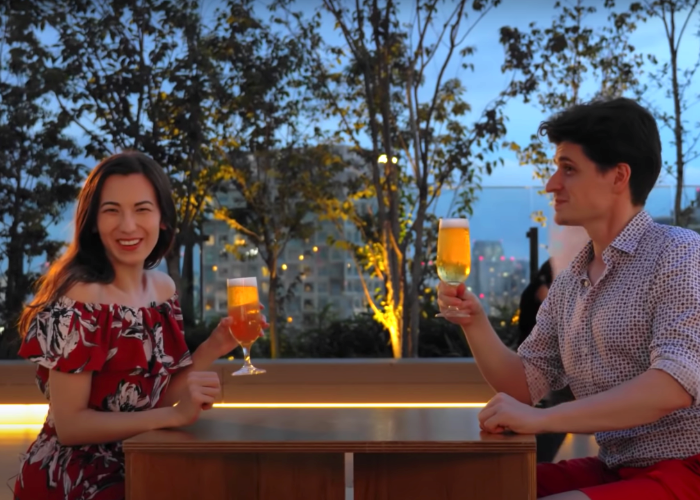 Shizuka Anderson and Kyle Card with glasses of beer on the Tokyo rooftop Shibuya Parco