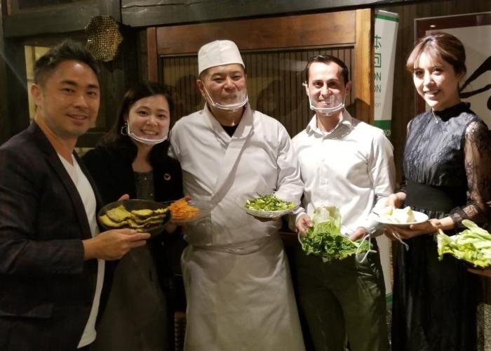 Chef Suzuki with the byFood and CRUST team at the sustainable dinner event holding up food scraps