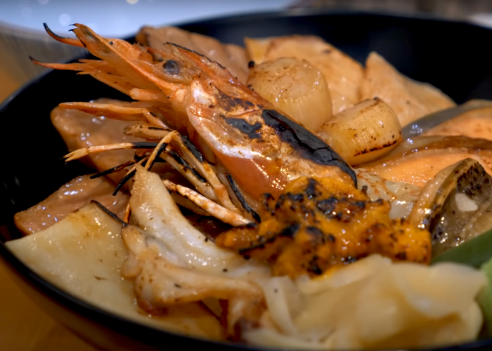 Seared seafood donburi from Tsukiji market featuring a large shrimp