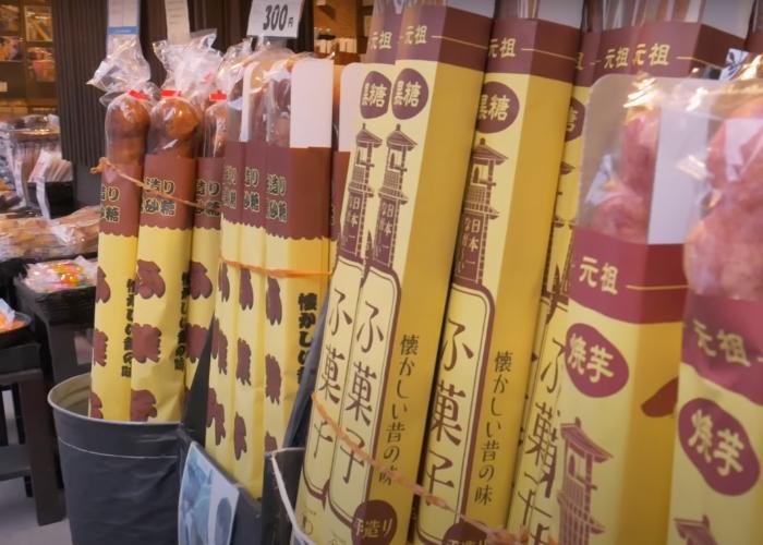 Barrels of giant sweet potato breadsticks being sold outside a store in Kawagoe