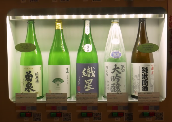 View of the Koedo Kurari sake vending machine with four bottles of sake