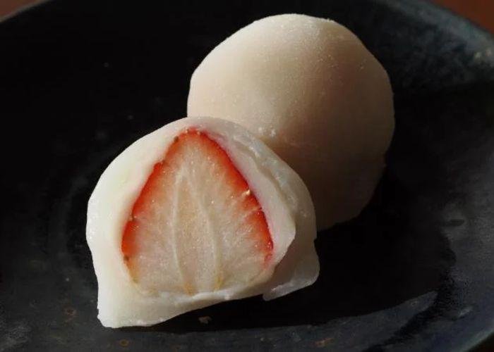 Close up of a strawberry mochi cut in half