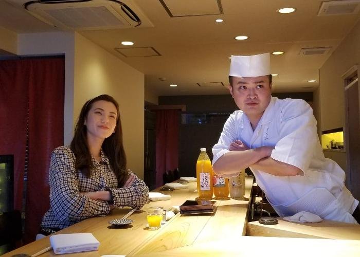 Shizuka and Chef Yuta at Sushi Rinda facing the camera, arms crossed