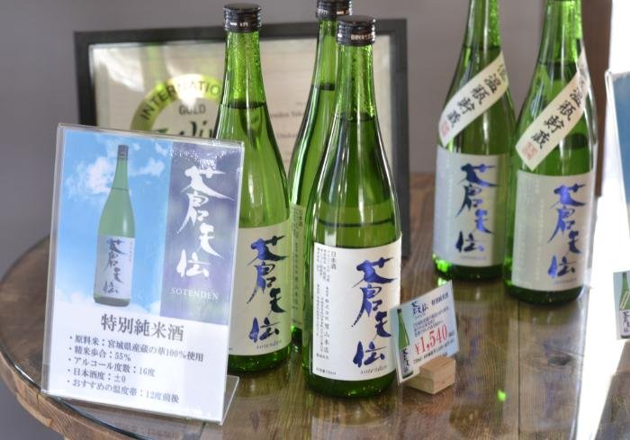 Green glass bottles of nihonshu at Otokoyama Honten Sake Brewery bottles