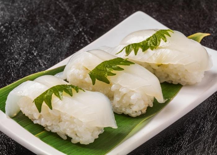Cuttlefish nigiri sushi on a white plate