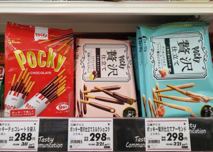 Packages of chocolate and almond pocky on grocery shelf