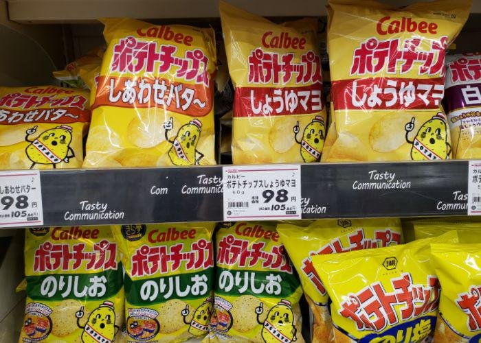 Packages of soy sauce mayo, shiawase butter, & nori Calbee chips on grocery shelves
