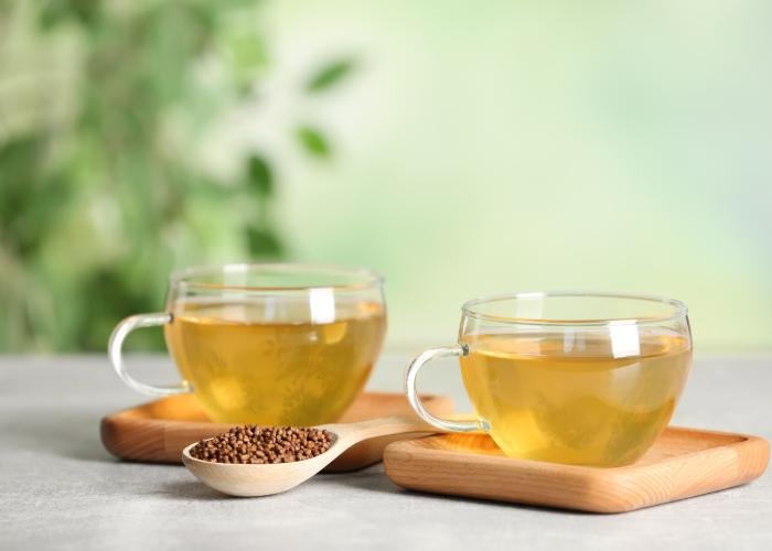 Sobacha buckwheat tea in clear teacups with a small dish of buckwheat