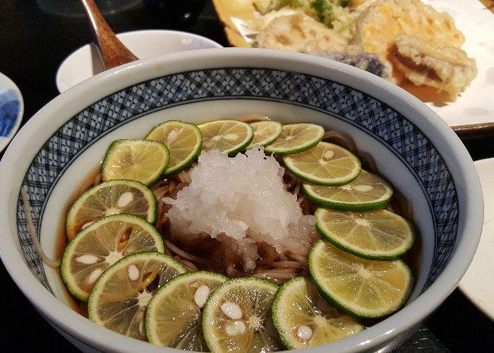 Sudachi soba, a bowl of noodles with slices of sudachi citrus lining the bowl