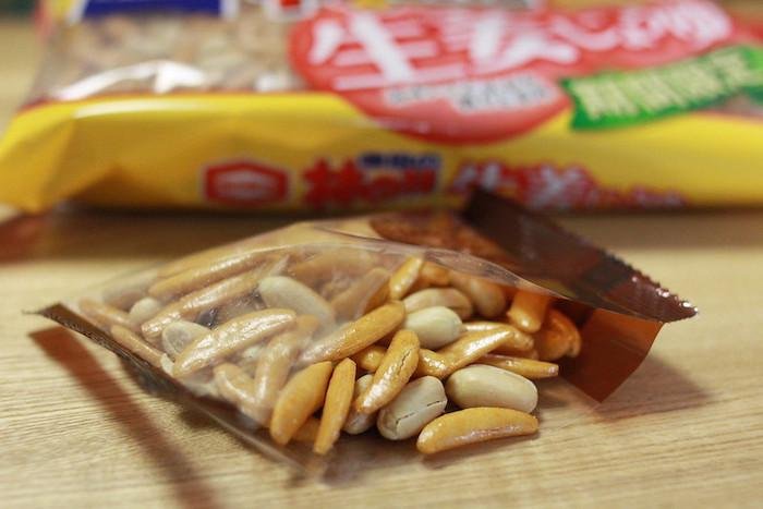 Kaki no Tane from Niigata, beer snack from Japan, the pack is open on a table with the main packet behind it