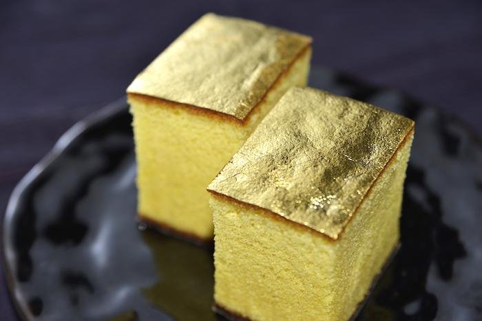 Castella Cake with Gold Leaf from Kanazawa in Ishikawa Prefecture on a plate with a dark background