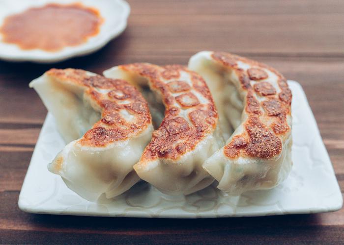 Utsunomiya gyoza, three pan-fried dumplings on a plate