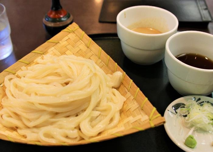Mizusawa Udon, a specialty of Gunma prefecture, with chilled udon noodles served on a bamboo plate and sesame dipping sauce