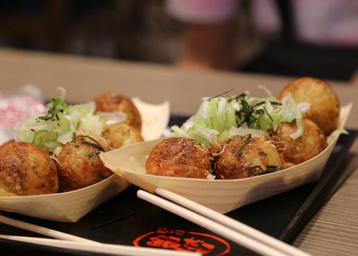 The famous takoyaki street food; octopus balls covered in sauce, seaweed and bonito flakes.