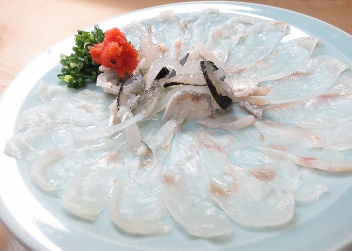 Delicate, transparent fugu sashimi laid out on a platter