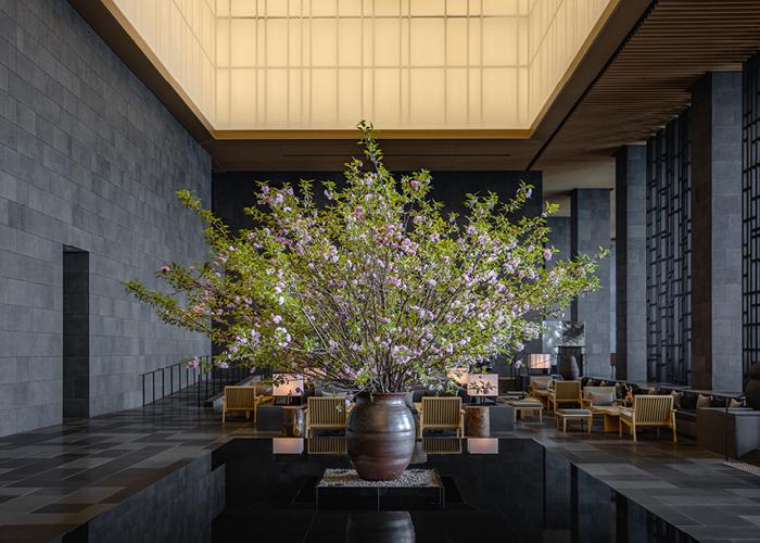 Image of Aman Tokyo lobby area with ikebana display