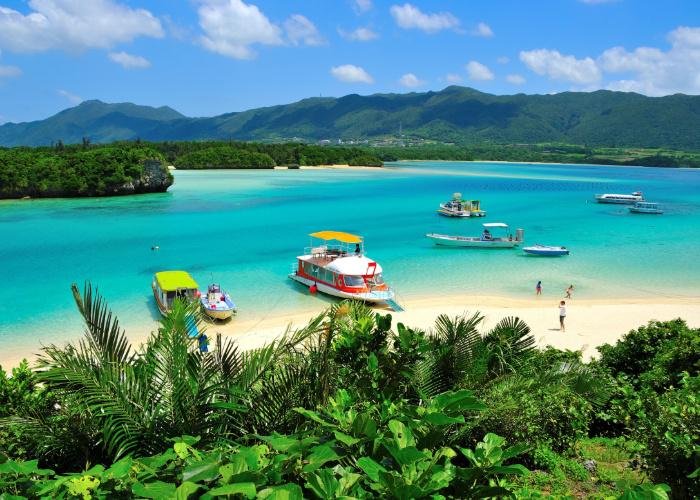 View of tropical Kabira Bay in Okinawa, with clear blue waters and a verdant green coast
