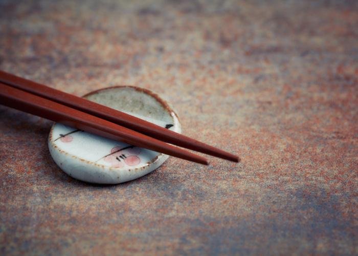 Hashioki, a Japanese chopstick rest made of ceramic with a pair of chopsticks resting on top