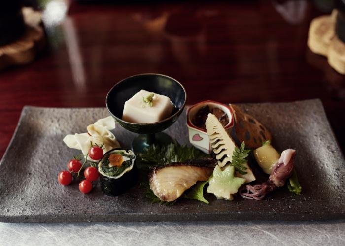 A rectangular platter with a variety of tofu, seafood and vegetables, part of a kaiseki meal in Kyoto, Japan