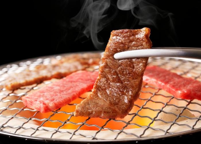 Yakiniku, Japanese BBQ, pieces of meat being grilled over coals