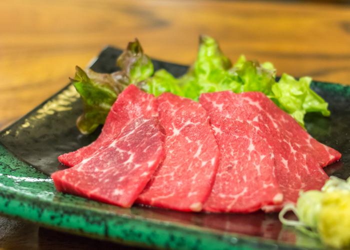 Thin slices of basashi horse meat sashimi.