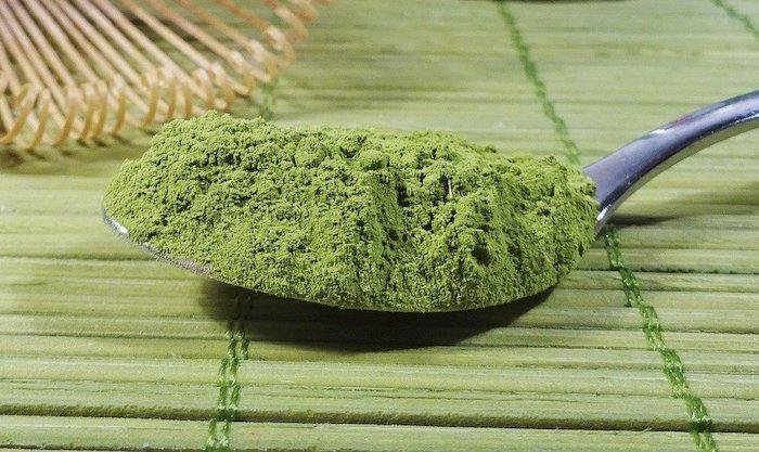 Matcha Green tea on a spoon on a bamboo mat