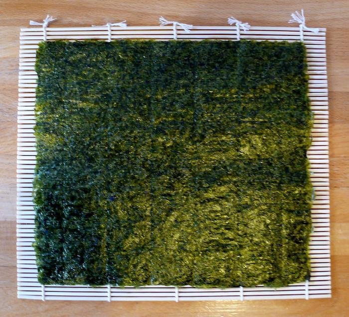 Sheet of nori seaweed on a bamboo sushi mat