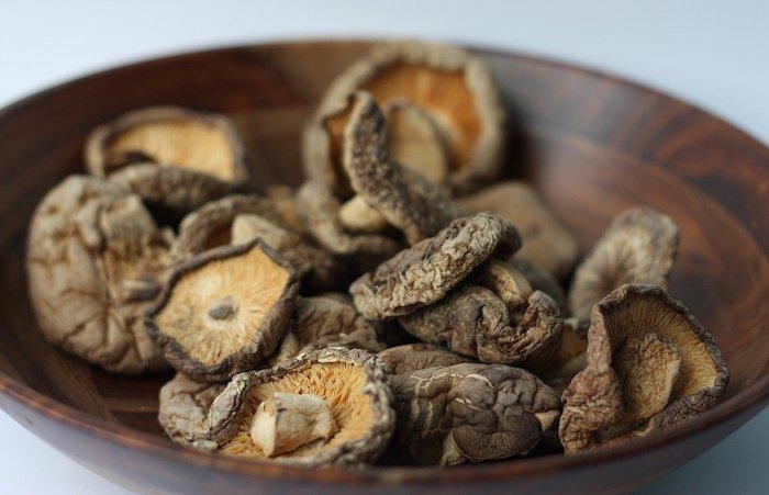 Dried shiitake mushrooms in a wooden bowl