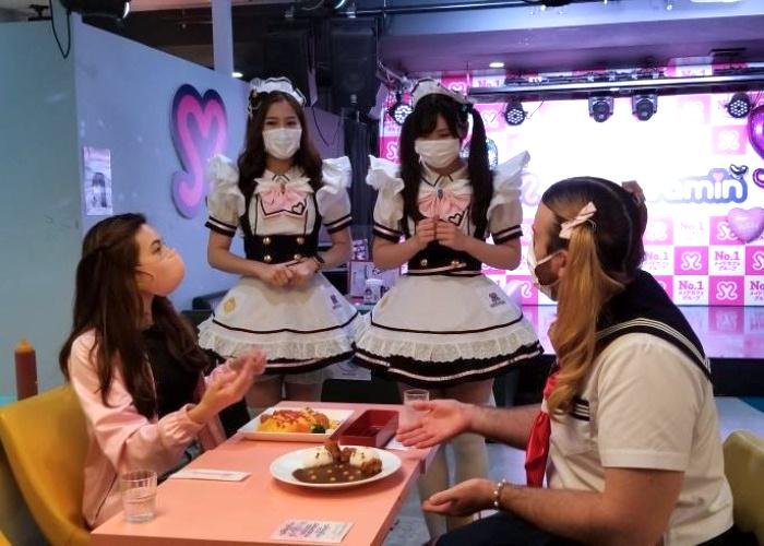Shizuka and LadyBeard sit at a table accompanied by two girls in maid costumes at Maidreamin Maid Cafe in Tokyo
