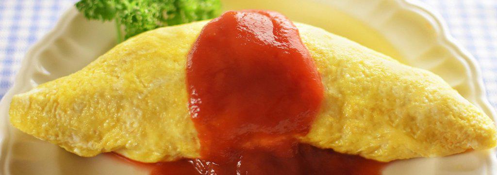 Fluffy omelette topped with rich tomato sauce