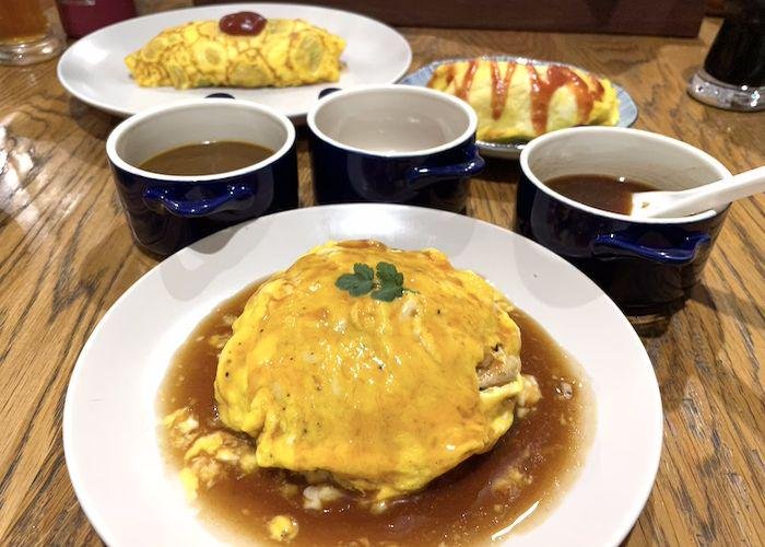3 Different Types of Omurice on a wooden table