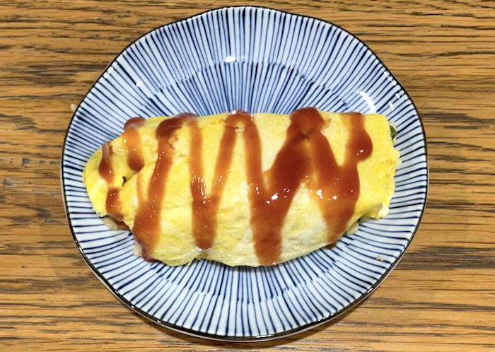 Homemade Omurice with tomato ketchup in a zigzag decoration