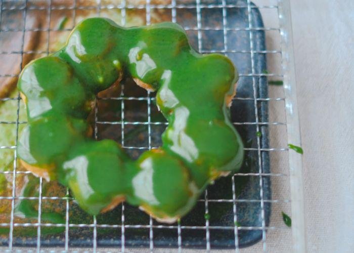 Mochi Donuts with white chocolate matcha glaze, cooling on a wire rack