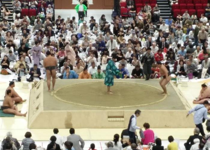 People watching a Sumo wrestling tournament in Ryogoku Kokugikan Sumo Hall