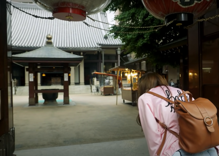 Shizuka Anderson bows outside of Toganji Temple in Sugamo