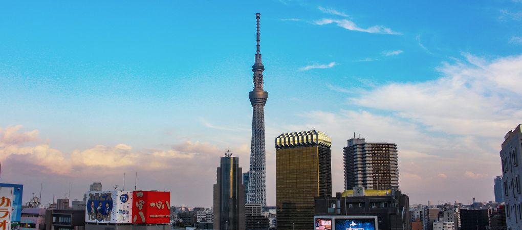 Tokyo Skytree towering over cityscape under a blue sky